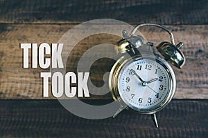 Tick tock day concept. golden alarm clock