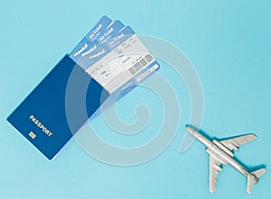Tickets for plane and passport, dollars with model of plane on blue background. Copy space for text photo