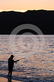 Silhouette of a tico fishing photo