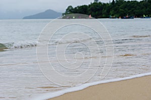 Tidal current wave flow to beach over sand