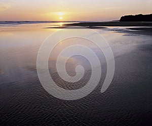Tidal flats and ocean at sunset