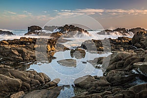 Tidal pools with rocks and waves of the ocean