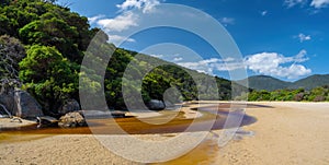 Tidal River with its distinct brown water flowing into the ocean.