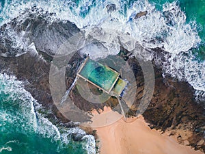 Tidal swimming pool built on a rock shelf surrounded by ocean