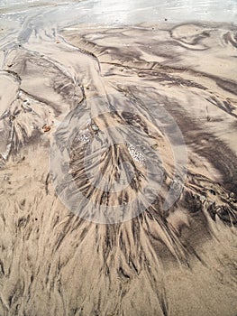Tidal watercourse and marks on the beach