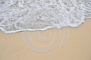 Tidal wave on a clean, sandy, sea beach