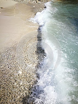 Tidal wave and rocky sand photo