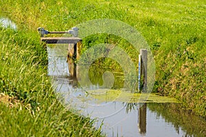 Tide gauge and small weir in a ditch