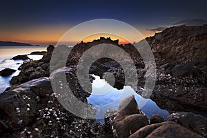 Tide pools at sunrise in kalim beach