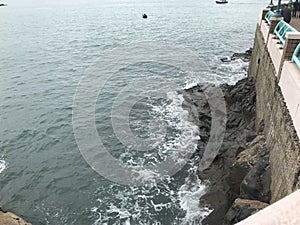 Tide waves dashing on the rocky beach