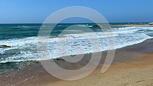 Tide waves on the ocean on a warm vacation day.