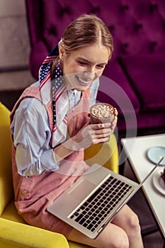 Tidy fashionable young girl working with laptop