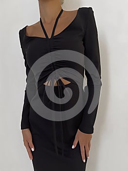 Beautiful black dress with slits on the female body photo