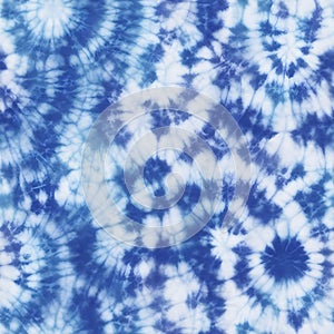 Tie dye design. Seamless repeating pattern. Dyed indigo fabric background and textured. Pattern of blue dye on cotton cloth,