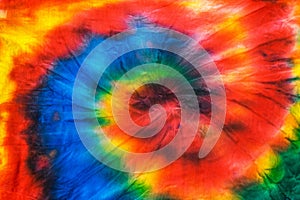 The tie dye spiral pattern on the fabric is hand-made. Flat lay.