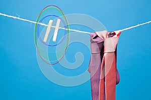 Tie and its knot on a rope held by a pair of tweezers