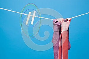 Tie and its knot on a rope held by a pair of tweezers