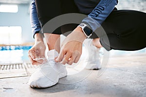 Tie shoes, hands and fitness at swimming pool to start workout, exercise or training. Sports, athlete and woman tying