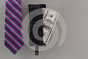 Tie and wallet with american dollars.