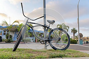 Tied bicycle on a metal posts near the road at La Jolla, California