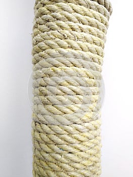 Tied braided thick rope on white background. Skein of rope jute. Rustic rope roll