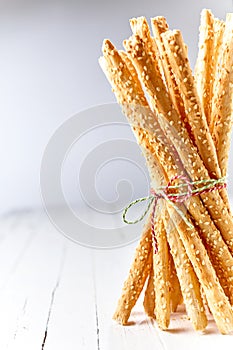 Tied bundle of grissini breadsticks with a twist