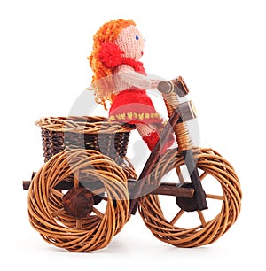 Tied doll on toy bike.