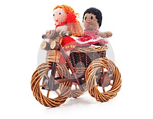 Tied dolls on toy bike.