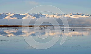 Tien Shan mountains near calm water of Son-Kul lake,natural landmark of Kyrgyzstan,Central Asia