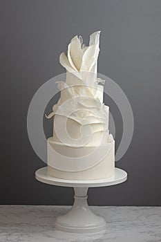 4 Tier Trendy Wedding Cake Decorated With Ruffles And Pulled Sugar photo