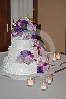 Tiered Wedding Cake with Candles, Roses, and Flowers