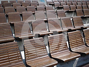 Tiers of wooden chairs in outdoor arena