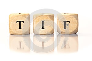 TIF spelled word, dice letters with reflection