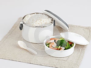 Tiffin carrier with rice and fried shrimps and bloccori