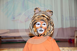 Tiger costume for school performance. mask for child.Children face painting. Boy painted as tiger or ferocious lion. Boy actor