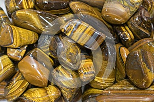 Tiger Eye Stones Ready to Make Handmade Jewelry. tiger`s eye and hawk`s eye gemstone as natural mineral rock specimen