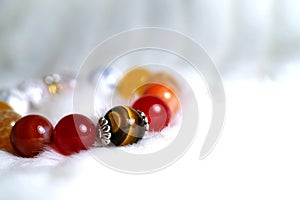 Tiger eye and various quartz lucky stone bracelet in red and white tone on white wool texture background