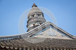 Tiger Hill Pagoda contrasted against a building in the foreground