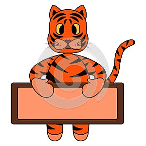 Tiger. A tiger cub holds an empty poster in its paws. Place for your text. Tabby kitten. Symbol of the year.