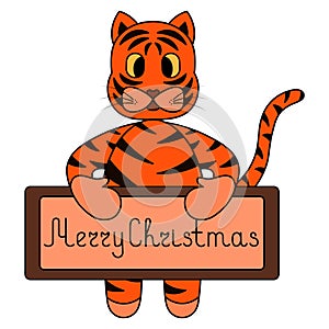 Tiger. A tiger cub holds a poster with a wish in its paws. Merry christmas. Tabby kitten. Symbol of the year. A ginger animal with