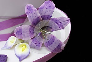 Tigerlily orchid in purple with calla lillies on a wedding cake