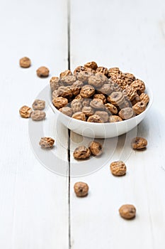 Tigernuts in a bowl on a wooden surface photo