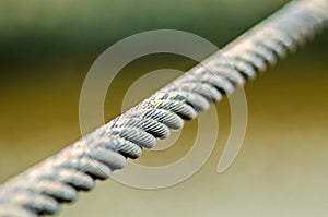 Tight steel cable on blury background photo
