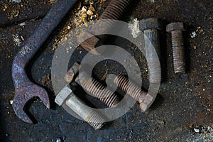 A tighten metal key for screw and some rusty screws