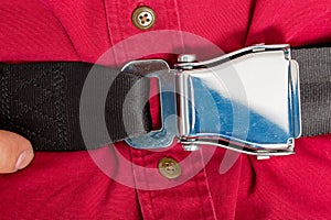 Tightly clinched seat belt buckle on a passenger