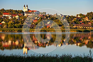 Tihany village and the abbey in warm sunset colors with the inner lake in the front and a beautiful refletion on water photo