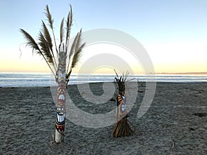 Tikis on the beach at sunrise