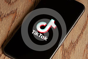 TikTok application icon on Apple iPhone 11 screen close-up.