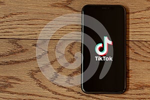 TikTok application icon on Apple iPhone 11 screen close-up.