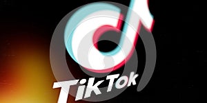 Tiktok logo on smartphone screen on black background. TikTok is a popular video-sharing social networking service owned